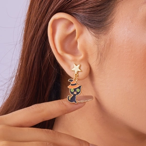 Detail of Halloween witch cat drop earring worn by model showing sizing and festive look