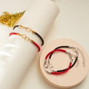 Couples heart friendship bracelets with red and black woven cords and metal heart charms