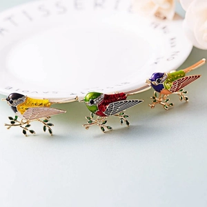 Exquisite enamel bird brooch set with sparkling rhinestones on golden leafy branches