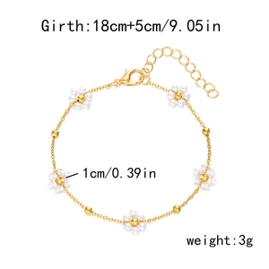 Floral pearl bracelet with five small flower charms on a delicate golden chain