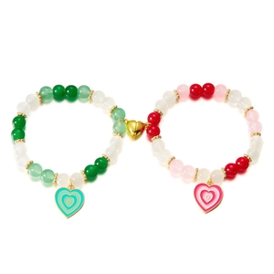 Dettaglio di due braccialetti di perline con chiusura magnetica a cuore dorata