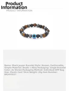 Detailweergave van de 8mm hematiet kralenarmband met een blauw evil eye symbool