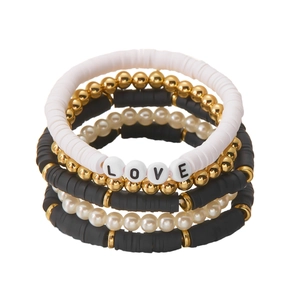Detail eines mehrlagigen LOVE-Armbandsets mit schwarzen Heishi-Perlen und Perlen