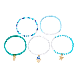 Detail of 5-piece Bohemian beaded bracelet set featuring pineapple and starfish charms