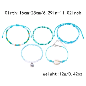 Detail of five-piece Bohemian handmade beaded bracelets with shell and evil eye charms