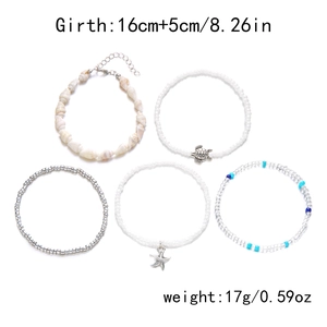 Detail of five-piece Bohemian beach bracelet set with natural shells and starfish charms