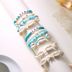 Detail of Bohemian beach bracelets with sea shell, starfish, and SEA SUN letter beads