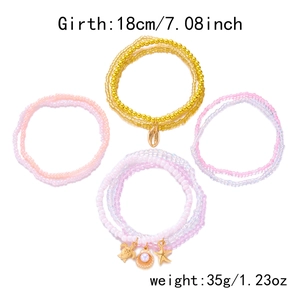 Detail view of multi-layer beaded bracelets with starfish, shell and turtle charms