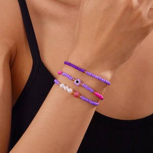 Detail von dreiteiligen böhmischen Evil-Eye-Perlenarmbändern mit bunten Meeresmotiven