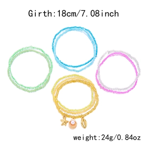 Detail of four multi-layer beaded bracelets with starfish, shell, and turtle charms