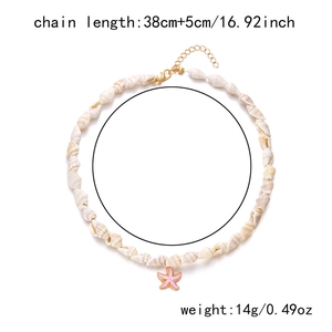 Detailed view of ocean shell necklace with pink starfish pendant and gold lobster clasp