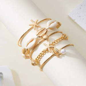 Detailed view of bohemian 5-piece sea shell bracelet set with starfish and pearl charms