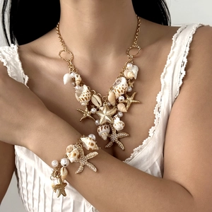 Close-up of bohemian shell waist chain with starfish pendants on a white summer dress