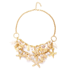 Macro view of ocean-themed belt chain with golden starfish, seashells and white pearls
