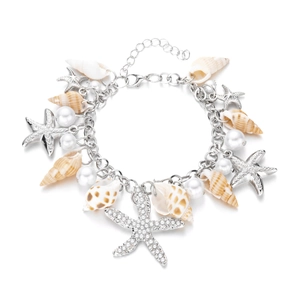 Detail of seashell starfish charm body chain with white pearls and silver metal links
