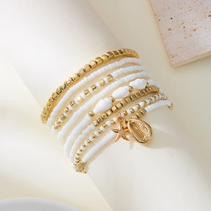 Detailed view of bohemian layered anklet set with starfish charms and white seed beads