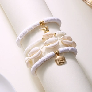 Detail of bohemian layered anklet set with starfish charm and natural seashells