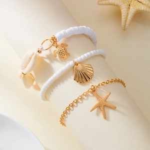 Detail of beach anklet set with starfish, seashell pendants and white beads on display