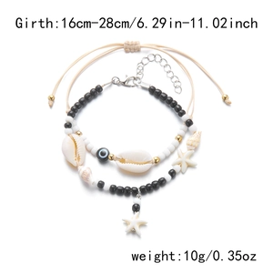 Detail of bohemian anklet set featuring starfish, shell, evil eye and colorful seed beads