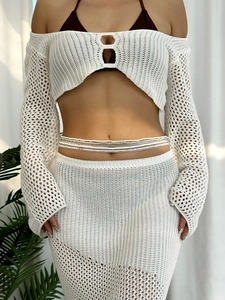 Detail of multi-layer boho beaded waist chain with cream and gold beads on beach model
