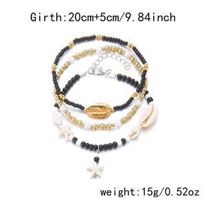 Detail of bohemian starfish and shell beaded anklet set showing gold charms and clasp