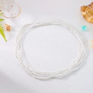 Close-up of layered white and silver seed bead waist chains with summer beach decor