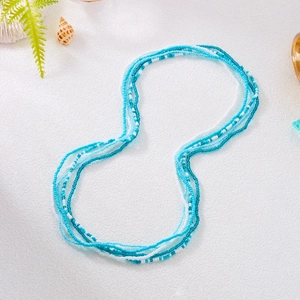 Detail of layered blue and white seed bead waist chain with summer beach vibe