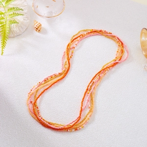 Detail of colorful multi-layered seed bead waist chains with vibrant summer beach charms