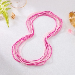 Detail of pink and white multilayer handmade glass seed bead waist chains on beach setting