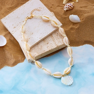 Dettaglio della collana di conchiglie intrecciata con pendente in madreperla lucida