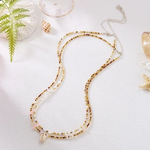 Detail of bohemian waist chain with shells, seed beads and adjustable metal clasp
