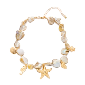 Detail of seashell necklace featuring golden seahorse, starfish and turtle charms