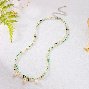 Detail of bohemian layered waist chain with green beads, stones and natural seashells