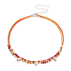 Detail of bohemian waist chain with colorful beads, seashells and red stone accents
