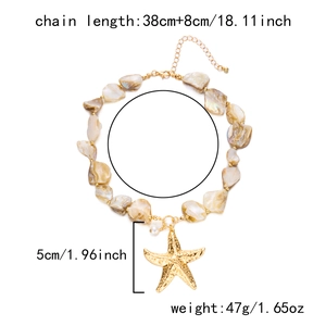Detail view of starfish pendant with pearl and shell bead necklace on white background