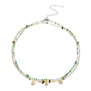 Detail of bohemian waist chain with sea shells, green beads, and silver extension chain