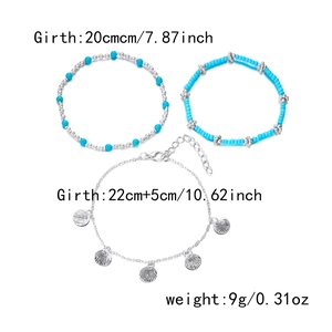 Detailed view of 3-piece layered anklet set with seashell charms and blue beads