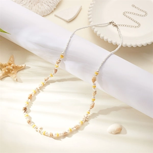 Detail of seashell beach waist chain with yellow beads and silver lobster clasp