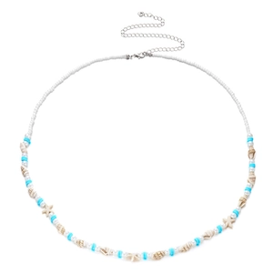 Detail of bohemian waist chain with sea shells, blue heishi beads, and star charms
