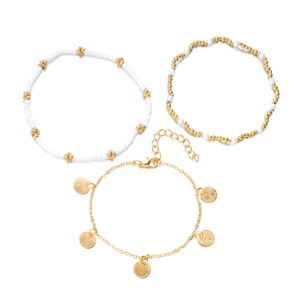 Close-up of bohemian layered anklets with starfish, shells and pearls for beach style