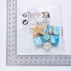 Detailed view of ocean style starfish and shell pendants with scale measurement