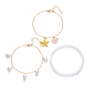 Detailed set of gold-tone anklets with starfish, shell charms and white pearl beads