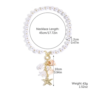Detail view of pearl necklace with starfish, shell charms, and golden beads on white background
