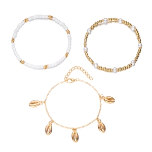 Detailed view of 3-layer bohemian anklet set with starfish, seashell charms and white pearls
