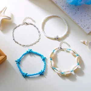 Detail of bohemian beach anklet set featuring starfish, shells, and turquoise beads
