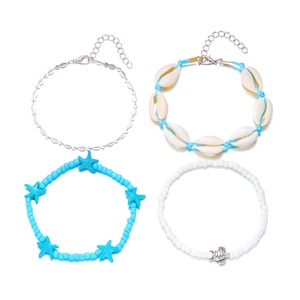 Detail of four-piece ocean charm anklet set featuring starfish and seashell beads