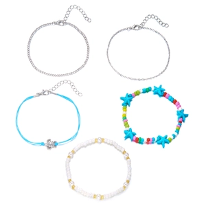 Detail of layered beach anklet set featuring silver starfish and turtle charms