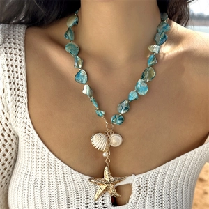Ocean style blue beaded necklace set with starfish, seashell pendants on female model