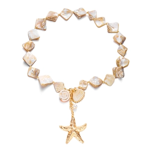 Detail of layered seashell necklace featuring gold starfish, scallop, and conch pendants