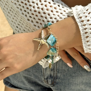 Detailed shot of starfish shell beaded bracelet with turquoise beads and faux pearls